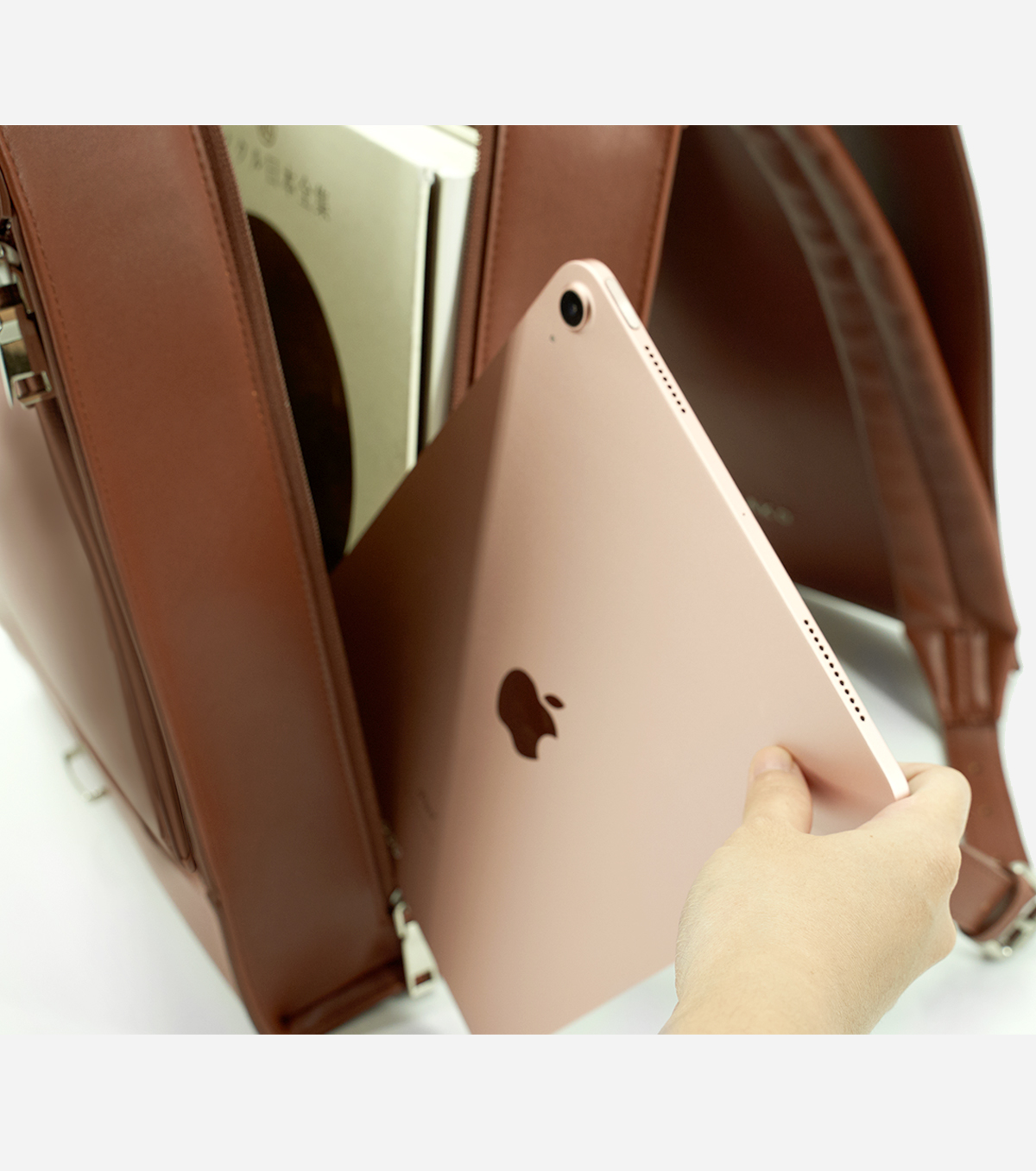 iPad and tech compartment of brown vegan leather backpack